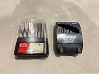Closed Jobmate spade bit holder and closed Mastercraft twist bit case side by side