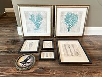 Group shot of all seven framed pieces on floor