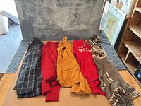 Five garments laid flat showing overall lot