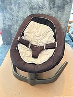 Front view of Nuna LEAF rocker showing overall design, seat pad and harness