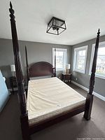 Full view of assembled queen four-poster bed with box spring