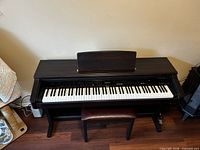 Front view of Roland KR-4500 piano with bench