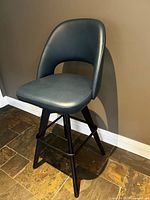 Front view of navy leather swivel bar stool showing seat, backrest and base