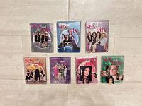 All seven Sex and the City DVD season sets arranged on floor