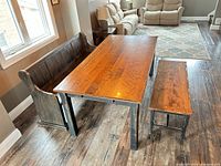 Dining table, pew, and bench arranged together