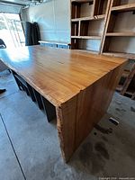 Three-quarter view showing live edge waterfall top and side panel