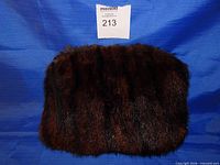 Front view of brown fur muff purse