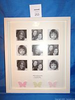 Full view of white Carlton "Motherhood" collage frame with nine photos and butterflies