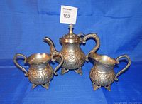 Front view of coffee pot, sugar bowl, creamer showing overall design