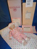 Doll, blanket pillow, box, certificate visible