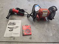 Bench grinder, angle grinder, manual and disc pack laid out