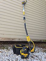 Full view of DeWalt pole saw, batteries, bag and sander