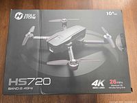 Retail box front showing HS720 model, 4K spec, 26-minute flight time