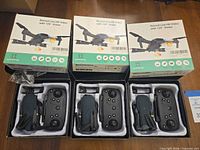 Four boxes showing drones with controllers and accessories