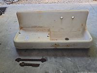 Front view of sink showing basin, washboard, faucet holes and rust