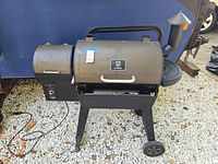 Front left view of Z Grills ZPG-450A pellet grill/smoker on two-wheel cart base with hopper and control panel
