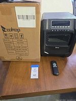 Heater, remote, and boxed packaging on table