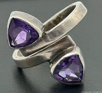 Front angled view showing bypass design and both trilliant amethysts