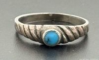 Front view showing turquoise cabochon and twisted band detail