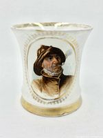Front of beaker showing Old Sea Captain portrait and gilt detailing