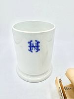 Front view of mug showing monogram and pedestal base