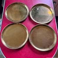 Top view of four round brass plates