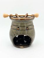 front view of ceramic oil burner showing opening and glaze