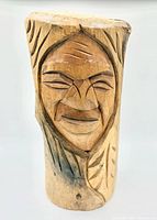 Front view of carved wood spirit face bust