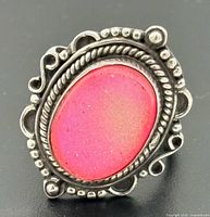 Front view of sterling silver ring showing pink stone and ornate bezel
