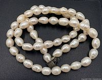 Full view of pearl necklace showing strand and broken clasp