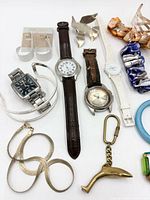 Overall view showing watches, bracelets, brooch, earrings, keychain