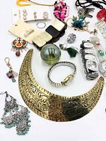 Overview of assorted jewellery and watches showing key items like brass collar, watches, earrings