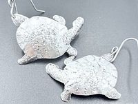Front view of both hammered sterling silver sea turtle earrings