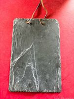 Front view of rectangular slate board with leather loop