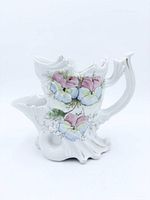 Full right-side view showing floral decoration, handle, brush holder