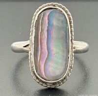 Front view showing abalone cabochon, bezel and border