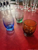 Front angle of the three colored etched shot glasses on tabletop