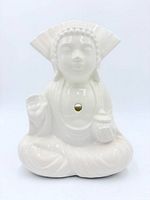 Front view of white glazed seated Buddha ceramic mug with straw hole