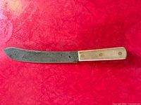 Full view of knife blade and handle, blade patina visible