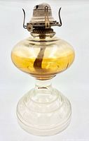 Full view of lamp showing amber font and metal burner