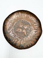 Top view showing full hammered copper dish with star motif