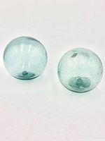 Both glass floats side by side showing overall form and color