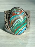 Front view showing oval Rainbow Calsilica cabochon and openwork band detail