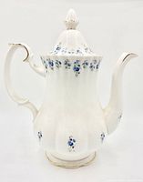 Full side view of coffee pot showing shape, handle, spout, floral pattern and gold trim