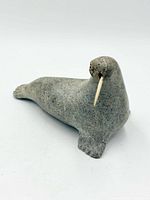 Oblique front view of stone walrus showing body shape and tusk