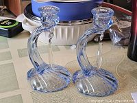 Full view of both candlesticks showing color, design and condition