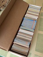 Open long box filled with stacked trading cards