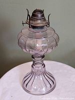 Full view of amethyst pressed glass oil lamp
