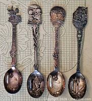 All four collectible spoons laid out showing handles and bowls