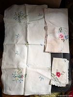 All three embroidered linens laid out